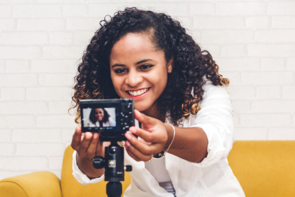 Woman Business Owner Adjusting Video Camera